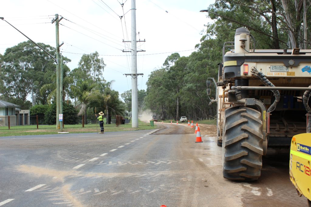 Image shows road work construction and traffic controllers