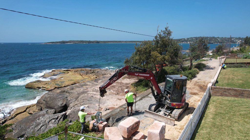 Image shows convil group constructing a sea wall embankment at Cronulla